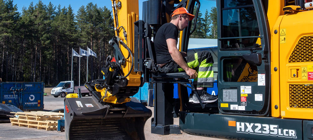 Patrik entering his customised HX235L CR crawler excavator.